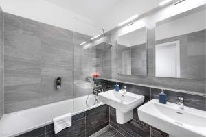 a bathroom with a sink and a mirror at CityWest Apartments in Prague