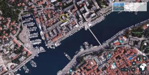 an overhead view of a harbor with a yellow circle at Voshta 2 bedroom apartment in Zadar