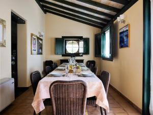 a dining room with a table and chairs at La Casetta Sicilian Cottage in Case Rosolia