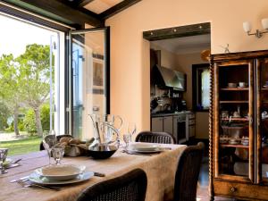a dining room table with chairs and a large mirror at La Casetta Sicilian Cottage in Case Rosolia