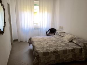 a bedroom with a bed and a window at Casa Liliana in Levanto