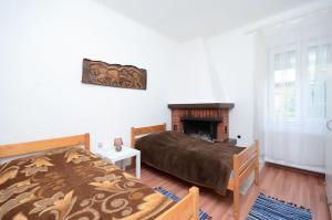 a bedroom with a bed and a fireplace at Apartments Andrijana in Rijeka