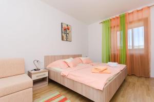 a bedroom with a bed with pink and green curtains at Apartment Branko in Lopar