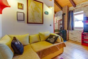 a living room with a yellow couch and a tv at House Nevenka in Štivan