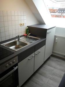 a kitchen with a sink and a counter top at Apartment Central in Erfurt