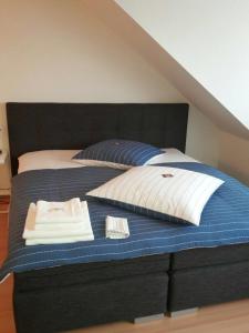 a bedroom with a bed with a blue and white blanket at Apartment Central in Erfurt