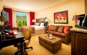 a hotel room with a bed and a living room at The Lodge at Jackson Hole in Jackson