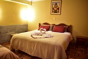Giường trong phòng chung tại Kuska Hostal