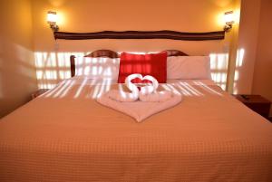 Giường trong phòng chung tại Kuska Hostal