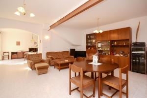 a kitchen and living room with a table and chairs at House Marija in Fažana +18 photos