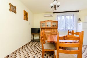 a kitchen and dining room with a table and chairs at Apartments Dragutin in Medulin