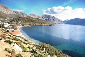 a view of a beach with mountains in the background at Themelina Studios in Emborios Kalymnos