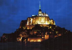 a castle sitting on top of a mountain at night at Chambres Les Salles in Beauvoir