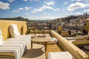 a balcony with a couch and a table and a city at Dar Gnaoua in Fez