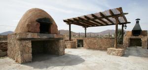a large brick oven with a wooden roof on top at Agroturismo La Gayria in Tiscamanita