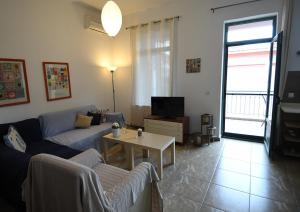 a living room with a couch and a table at Sofokleous Apartment in Kavála