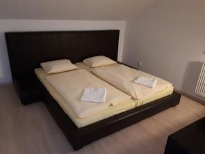 a bed with two pillows on it in a bedroom at Podkrovný apartmán v Smokovec in Smokovce