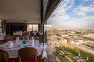 a restaurant with a view of a city at Palais Ommeyad Suites & Spa in Fès