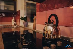 a tea kettle sitting on top of a stove in a kitchen at Sweet Apartment in Bihać
