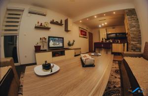 a living room with a couch and a table at Brilliant Apartman in Bihać