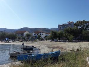 two boats sitting on the shore of a beach at Hotel Prinos in Prinos