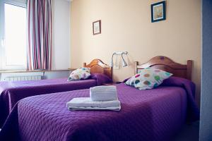 A bed or beds in a room at Hostal Goya II