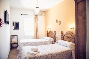 A bed or beds in a room at Hostal Goya II