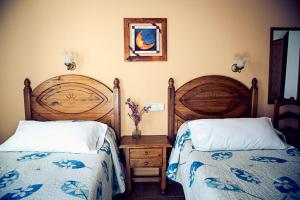 A bed or beds in a room at Hostal Goya II