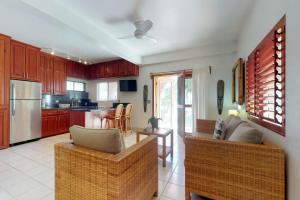 a kitchen with two couches and a living room at Oleander @ Caribe Island in San Pedro