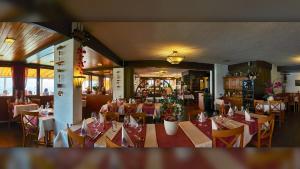 a restaurant with tables and chairs in a room at Hotel Restaurant Panorama in Aeschlen +32 photos