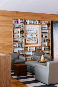 a living room with couches and bookshelves at The Study at University City, Study Hotels in Philadelphia