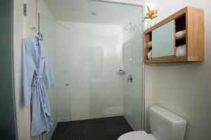 a bathroom with a toilet and a glass shower at The Study at University City, Study Hotels in Philadelphia +26 photos
