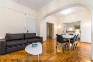 a living room with a couch and a table at Victoria Queens Paradise Apartments in Athens