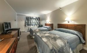 Ένα ή περισσότερα κρεβάτια σε δωμάτιο στο Chebucto Inn