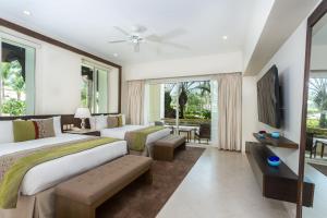 a hotel room with two beds and a television at Grand Velas Riviera Nayarit in Nuevo Vallarta