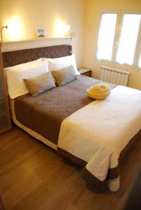 a large bed in a bedroom with two windows at Burlamacco Gold in Viareggio