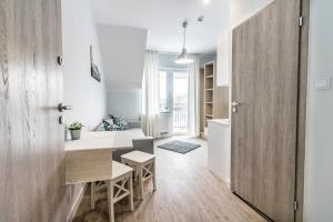 a kitchen and dining room with a table and a door at Novomiejska 17 in Lublin
