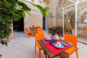 a patio with a table and chairs and a table and chairs at Corte dei Memoli in Lecce