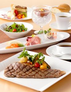 a table with three plates of food on it at Haneda Excel Hotel Tokyu Haneda Airport Terminal 2 in Tokyo