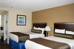 two beds in a hotel room with two beds at Executive Inn in Milpitas