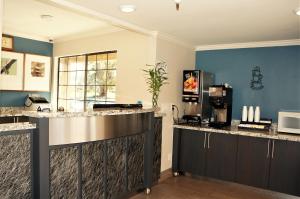 a kitchen with blue walls and a counter top at Executive Inn in Milpitas