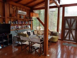 a living room with a couch and a table at Casa Naturalis Iguazú in Puerto Iguazú
