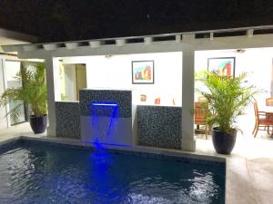 a swimming pool in a house with a water fountain at The Oasis Retreat in Nassau