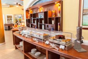 a buffet line with food on display in a restaurant at Breakfast at Monaco - Palais Boracay in Boracay
