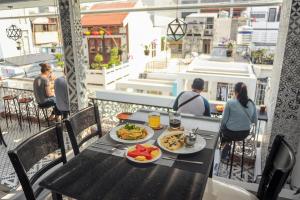 a table with plates of food on a balcony at My Anh 120 Central Saigon Hotel Ben Thanh Market in Ho Chi Minh City