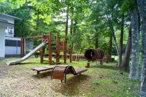 einen Park mit Spielplatz mit Rutsche und Bänken in der Unterkunft Asia Hotel FUJISAN in Yamanakako
