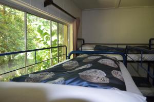 a bedroom with a bed and a large window at Mountain View Holiday Retreat in Harrietville