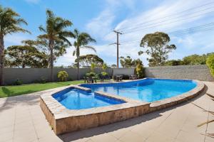 a swimming pool in the backyard of a house at Adelaide Road Motor Lodge in Murray Bridge