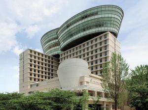 an office building with a curved roof at City Plaza Osaka in Osaka