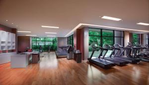 a gym with treadmills and ellipticals in a room at Grand Hyatt Dubai in Dubai